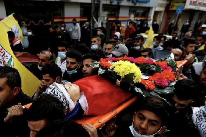 Palestinianos transportam o corpo do jovem Ali Abu Alayya durante o funeral do jovem assassinado por tropas israelitas, em Al-Mughayyer, Palestina, a 5 de Dezembro de 2020