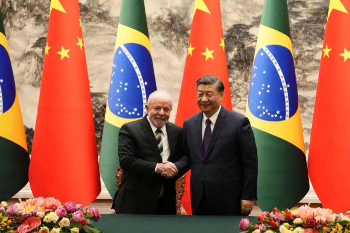 Os presidentes Lula da Silva (Brasil) e Xi Jinping (China) cumprimentam-se após a cerimónia assinatura de 15 acordos comerciais e de parceria entre os dois países. Pequim, 14 de Abril de 2023