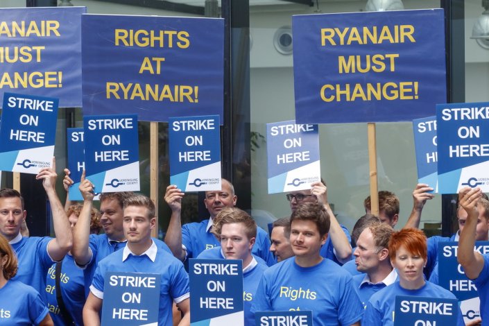 Pilotos da companhia aérea de baixo custo irlandesa seguram cartazes onde alertam para a necessidade de uma nova política de gestão, no aeroporto internacional de Frankfurt durante uma greve de pilotos da Ryanair em Frankfurt, na Alemanha, a 10 de Agosto de 2018