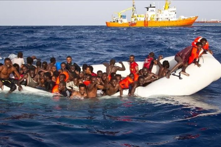 Grupo de migrantes, num barco de borracha, pede ajuda, no Mediterrâneo